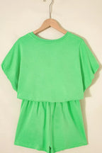 Pair of trendy solid color puffy loose drawstring shorts from Trendsi, shown in a 2-piece outfit set with rings.