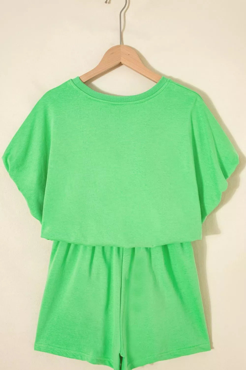 Pair of trendy solid color puffy loose drawstring shorts from Trendsi, shown in a 2-piece outfit set with rings.