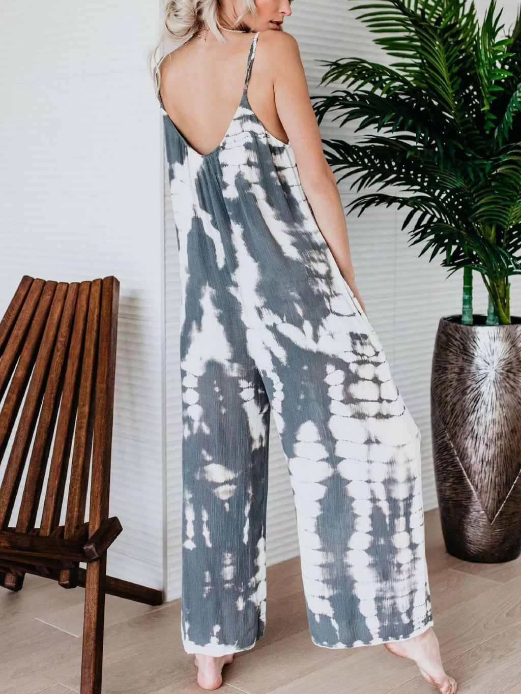 Plus size Shopimist tie-dye wide-leg jumpsuit laid flat showing vibrant colors and full length design.