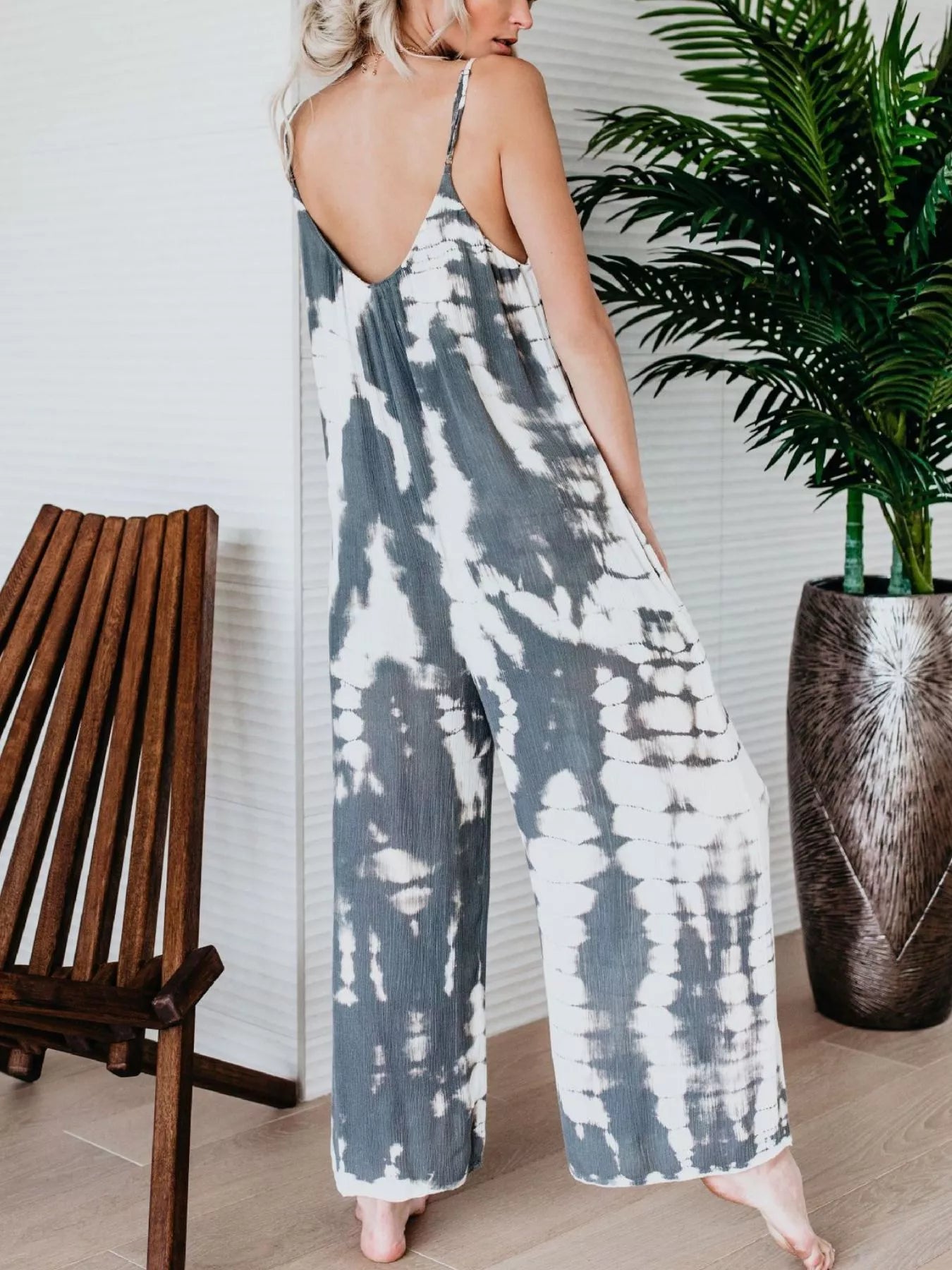 Plus size Shopimist tie-dye wide-leg jumpsuit laid flat showing vibrant colors and full length design.