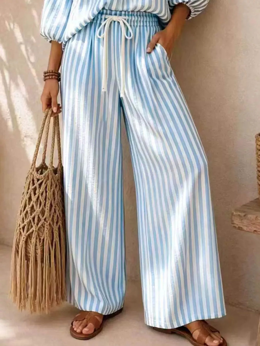 Plus size striped puff sleeve shirt and wide-leg drawstring pants set by Trendsi, featuring bold patterns and comfortable fit.