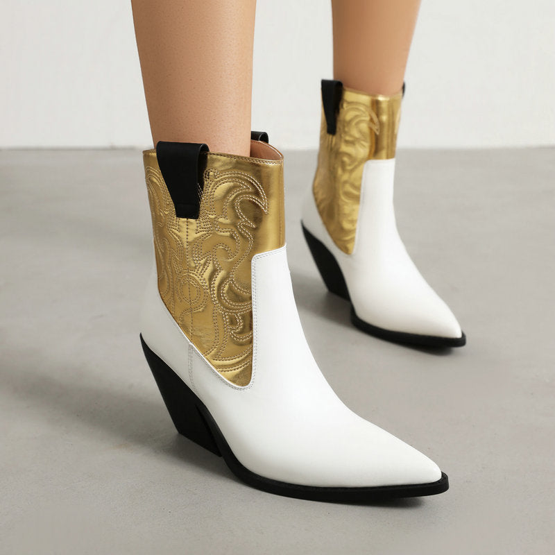 White and metallic gold leather cowboy boots with pointed toes, black pull tabs, and angled heels.