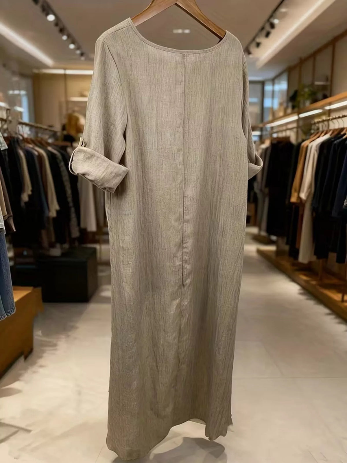 High-low hem blouse with roll-up sleeves from Trendsi, featuring a stylish design and lightweight fabric, shown on a model.
