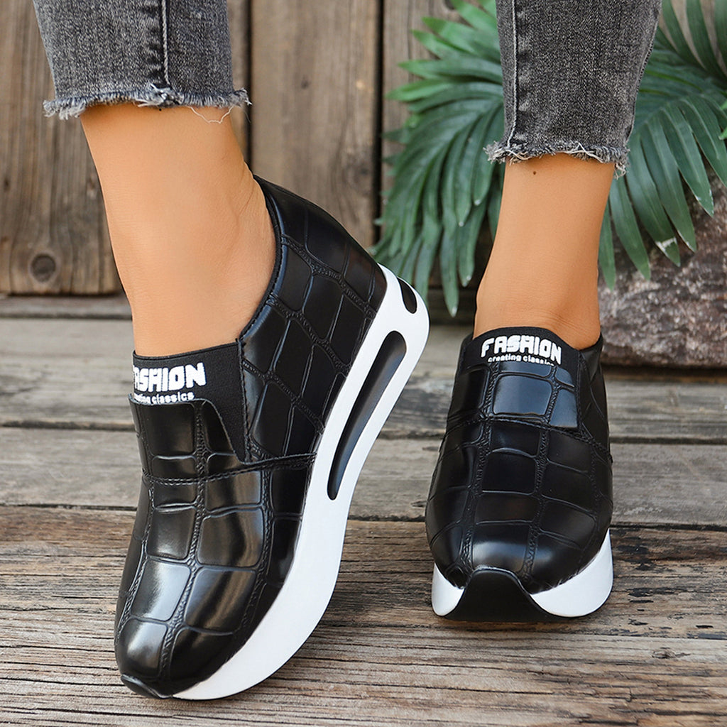 Women's crocodile pattern platform slip-on sneakers by Trendsi, faux leather casual shoes, showing the textured crocodile design and chunky sole.