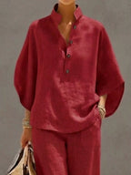 Plus size women's two-piece dress set with button details and 3/4 sleeves, featuring a top and matching pants from Trendsi.
