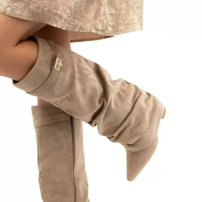 Beige faux suede slouchy knee-high boots featuring a pointed toe, side zipper, and gold-toned buckle detail.