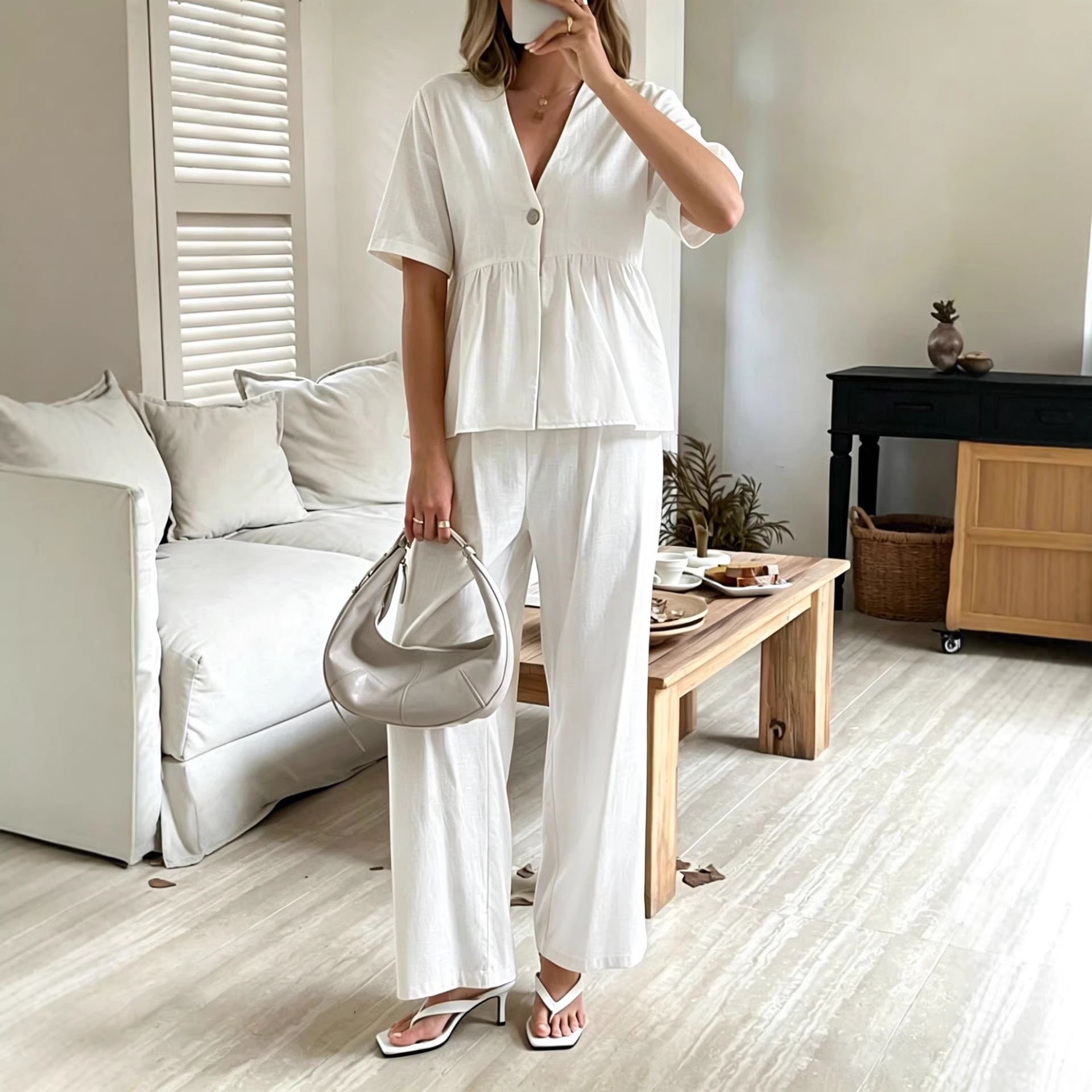 Women's casualwear set by FitiqueFit featuring a V-neck loose short-sleeve top and wide-leg pants, styled for comfort and style.