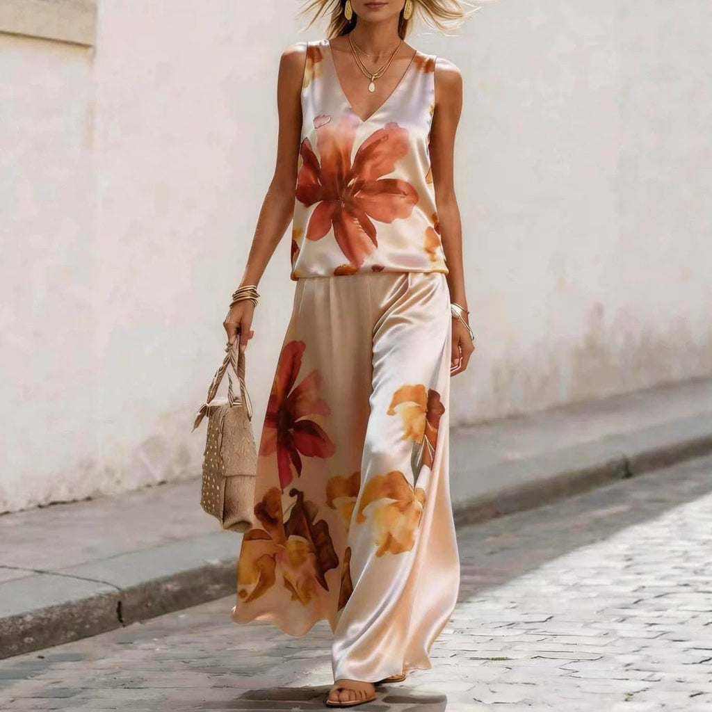 Women's floral printed sleeveless vest and pants two-piece set by FitiqueFit, featuring a colorful floral design and comfortable fit.