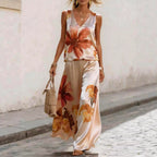 Women's floral printed sleeveless vest and pants two-piece set by FitiqueFit, featuring a colorful floral design and comfortable fit.