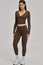 Fitglutes Activewear Swoon Long Sleeve Crop Top, black athletic crop top with fitted long sleeves for workout and gym wear.