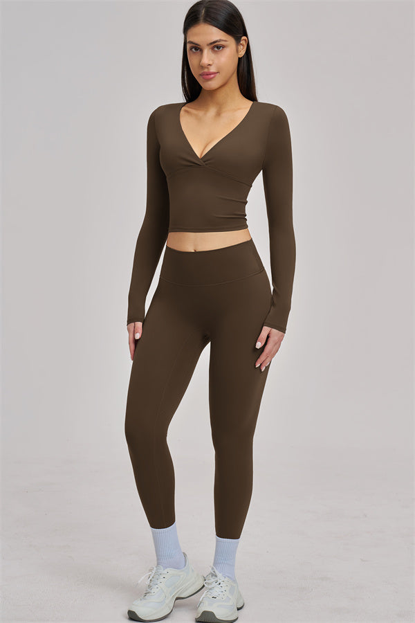 Fitglutes Activewear Swoon Long Sleeve Crop Top, black athletic crop top with fitted long sleeves for workout and gym wear.