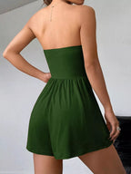 Chic strapless romper with ruched waist and trendy style, featuring a fitted bodice and flowing shorts, perfect for summer wear.
