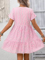 Lightweight plaid V-neck mini dress with ruffle hem from Plush Fashion Hub, perfect for seasonal fashion and casual wear.