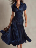 Pleated striped short sleeve midi dress by Trendsi, featuring a flowy design with vertical stripes and a fitted waist.