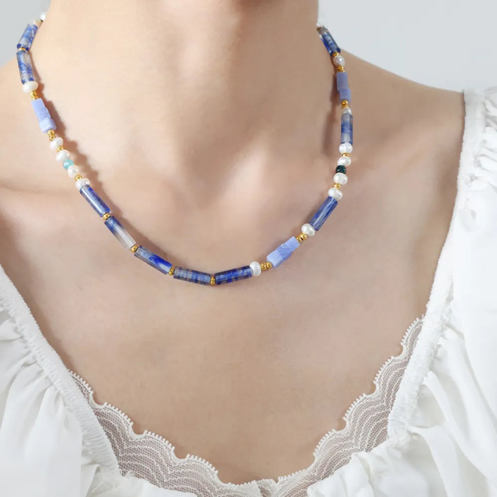 Freshwater pearl and geometric bead titanium steel necklace featuring modern design from Plush Fashion Hub