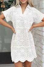 Solid color eyelet embroidered T-shirt mini dress by Trendsi, featuring short sleeves and intricate eyelet embroidery.