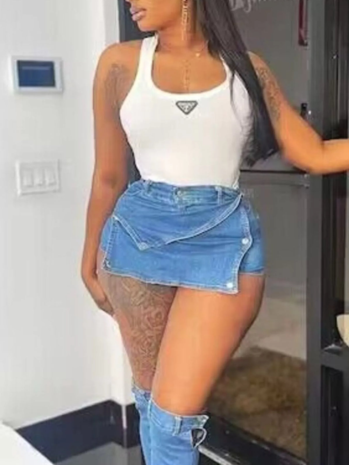 Asymmetrical wrap denim skort by Plush Fashion Hub featuring a stylish, fitted design with a unique asymmetrical hem in blue denim.