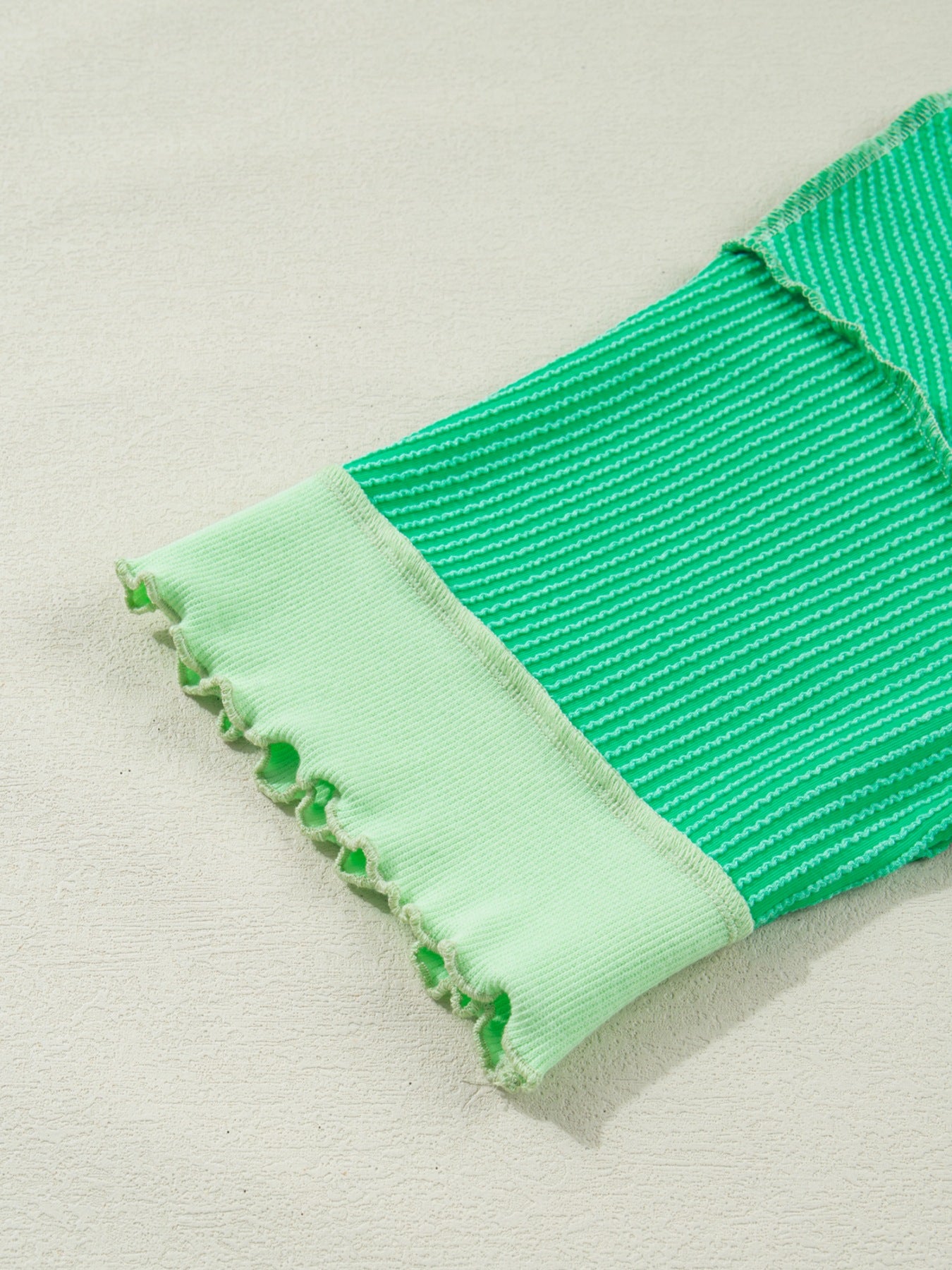 Women's ribbed twist hem short sleeve T-shirt with contrast stitching, casual fit, and stylish design from Trendsi.