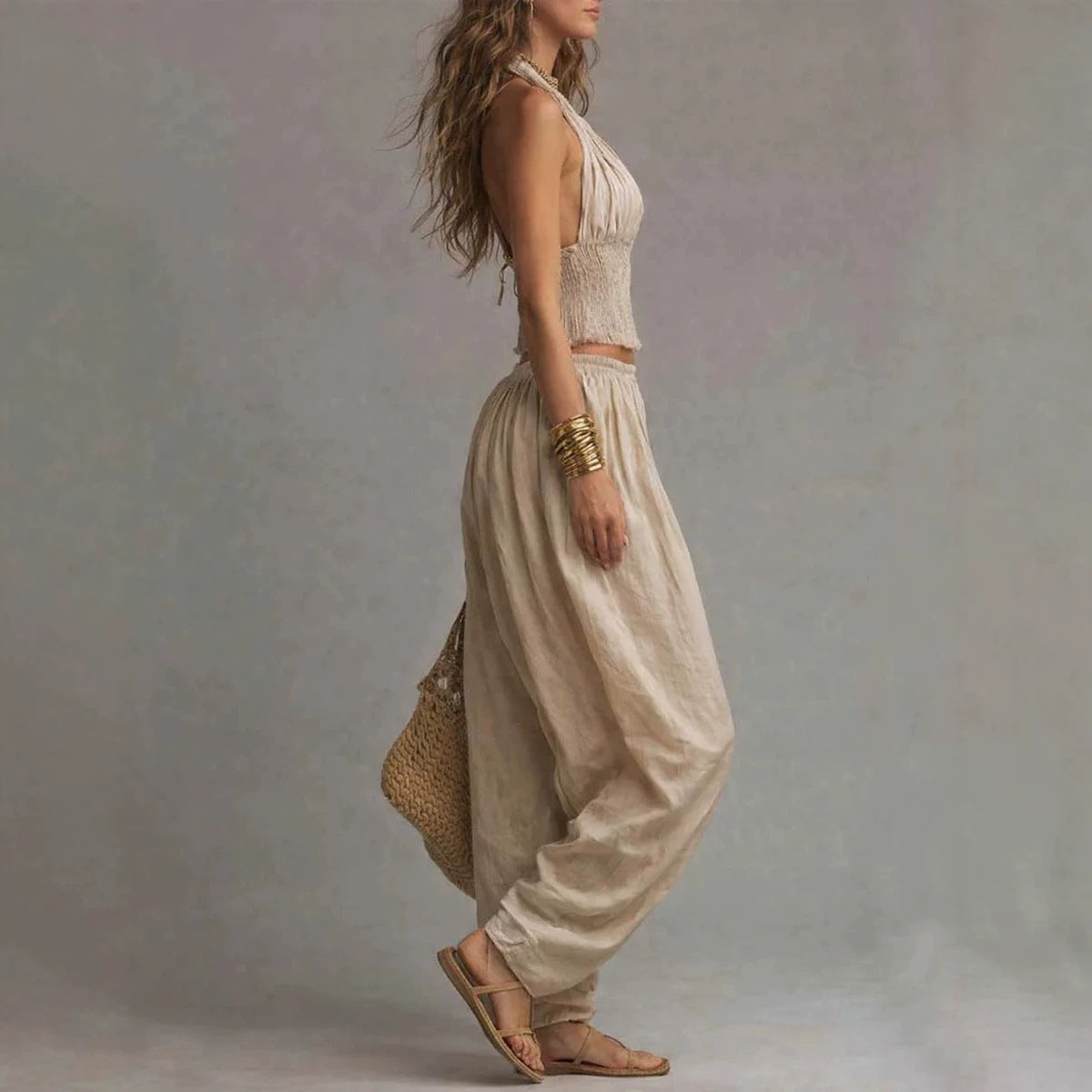 Women's sleeveless backless halter top and wide-leg pants set by FitiqueFit, featuring a stylish, coordinated fashion look.