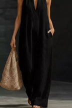 Women's sleeveless wide-leg jumpsuit with pockets, casual chic romper by Trendsi, shown in a stylish fit with pockets and relaxed silhouette.
