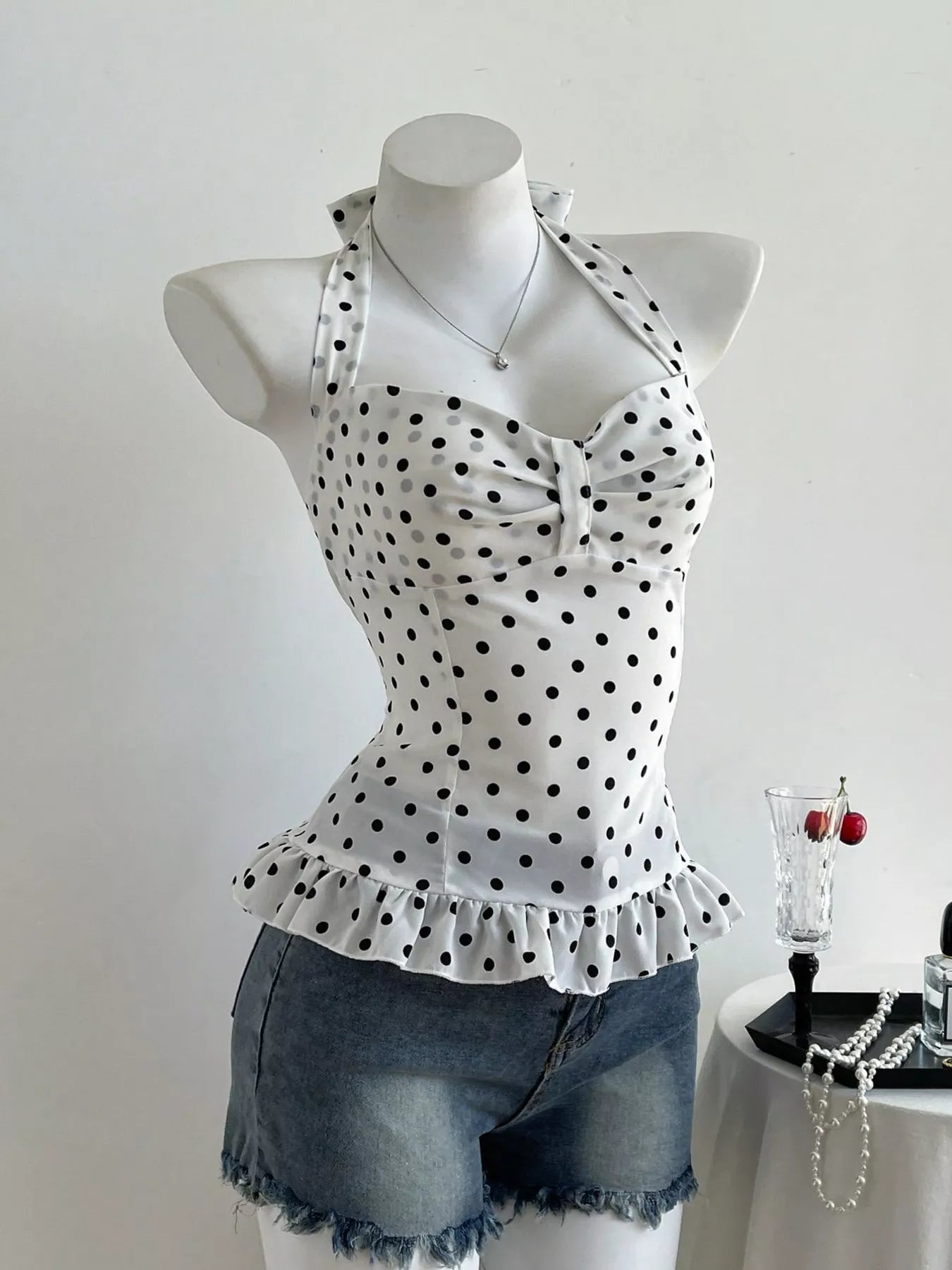 Polka dot halter neck camisole top by Plush Fashion Hub, featuring a stylish polka dot pattern and halter neckline.