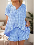 Gingham ruffle trim top and shorts set by Trendsi, featuring a stylish coordinated outfit with ruffled details and classic gingham pattern.
