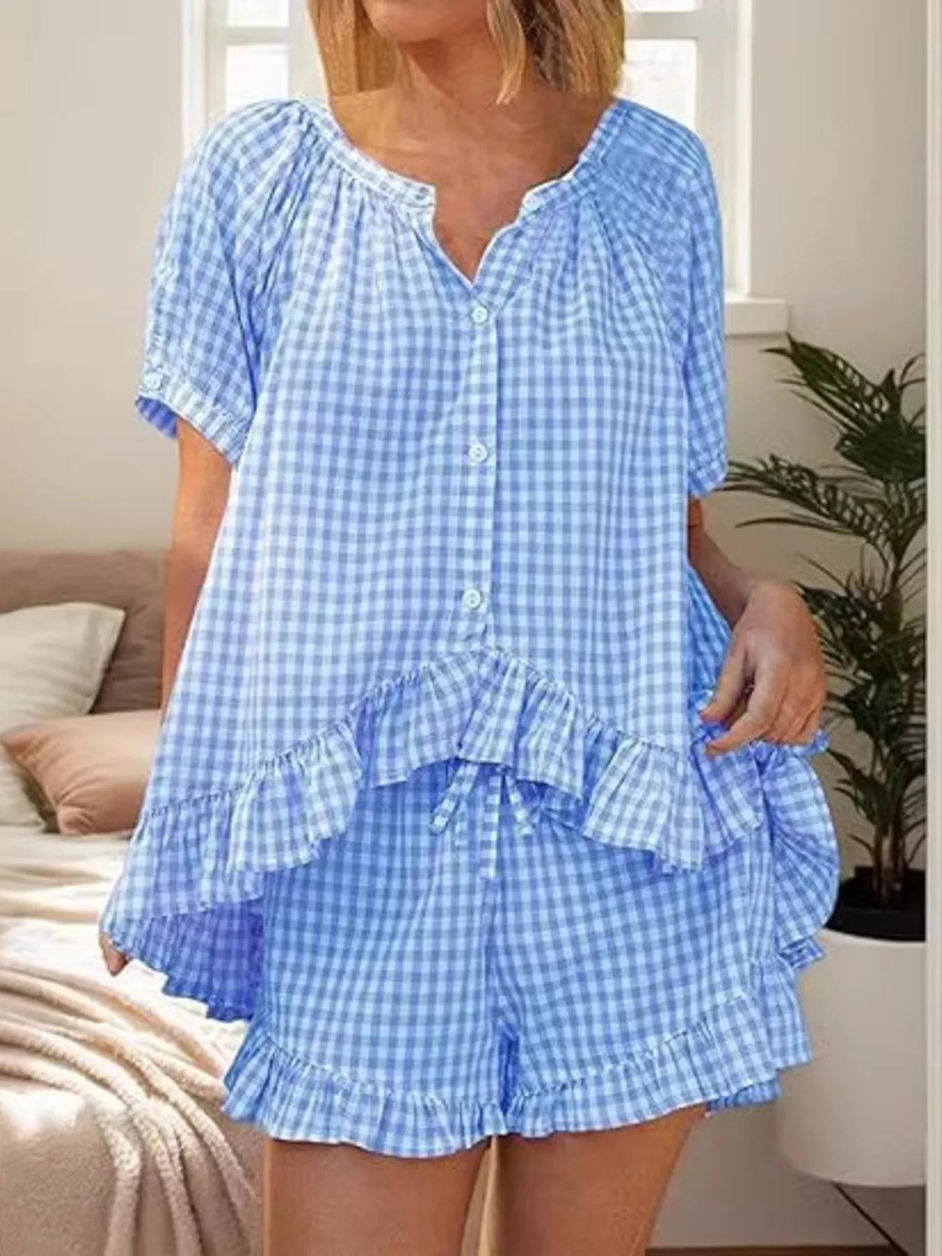 Gingham ruffle trim top and shorts set by Trendsi, featuring a stylish coordinated outfit with ruffled details and classic gingham pattern.