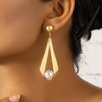 18K gold-plated pearl drop earrings with elegant white pearls and gold hooks, showcasing a sophisticated jewelry design.