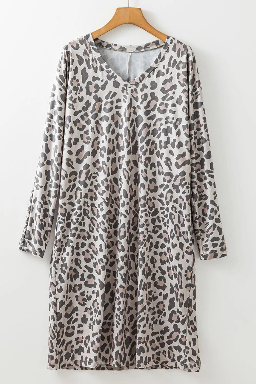 Leopard print V-neck long sleeve dress by Plush Fashion Hub, featuring a fitted silhouette and stylish design.