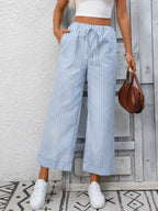 Women's striped wide-leg drawstring pants with pockets from Trendsi, featuring a relaxed fit and stylish design.