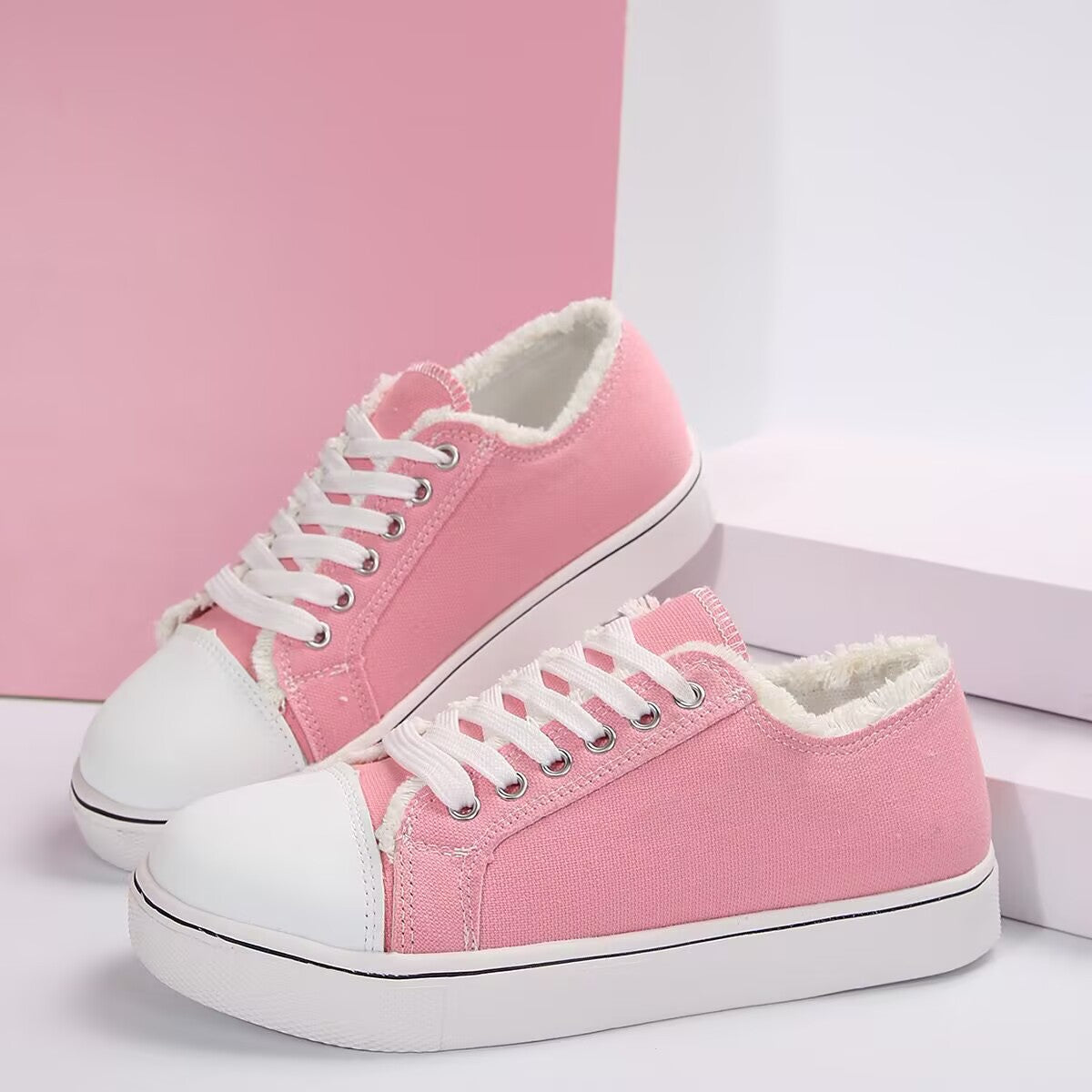 Women's lightweight canvas sneakers with lace-up design and flat low-top style from Plush Fashion Hub.