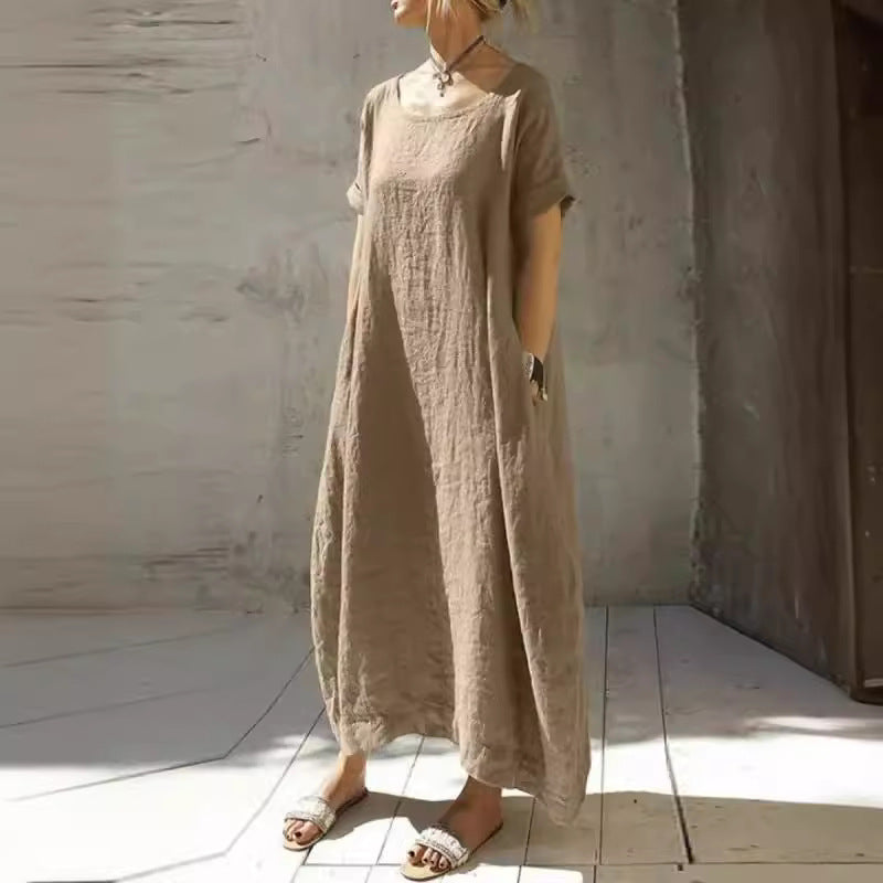 Solid taupe linen midi dress in a casual style with short sleeves, scoop neck, and side pockets.