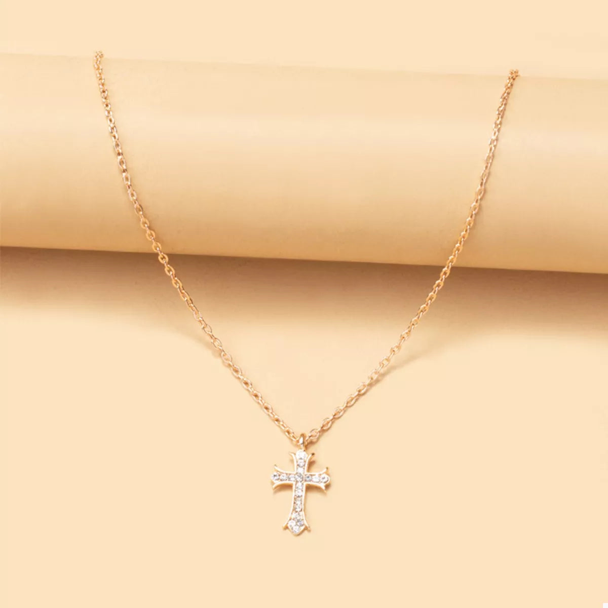 18K gold-plated rhinestone cross necklace with detailed pendant, featuring sparkling stones and a delicate chain.