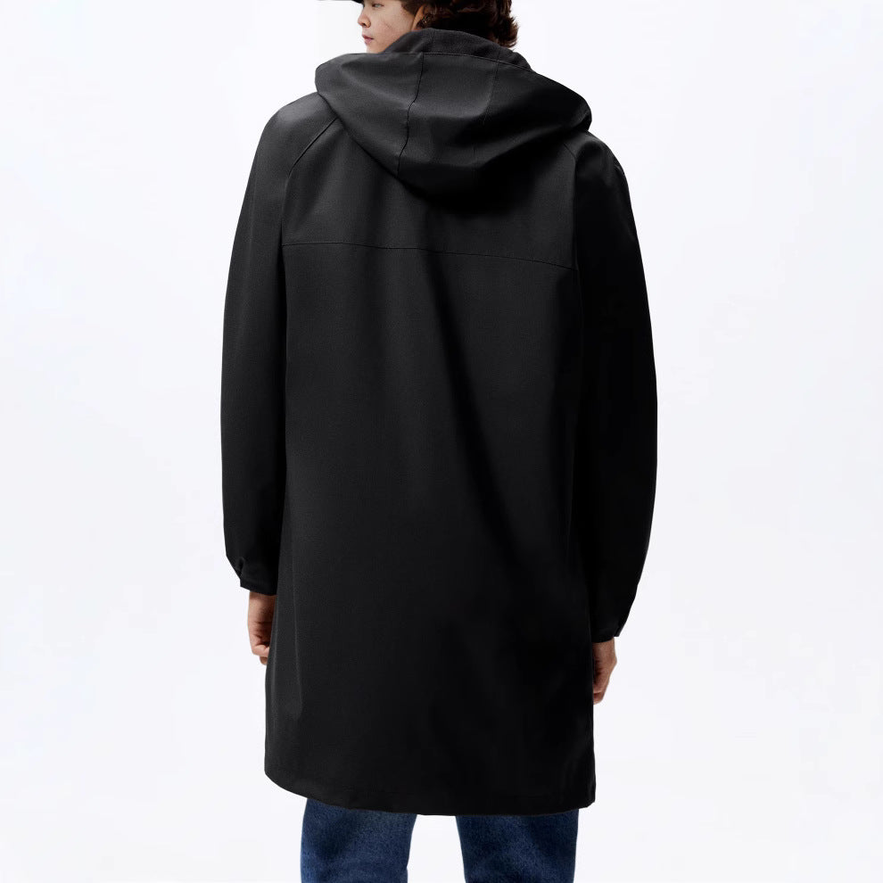 Back view of a person wearing a solid black hooded rain jacket with a smooth matte material.