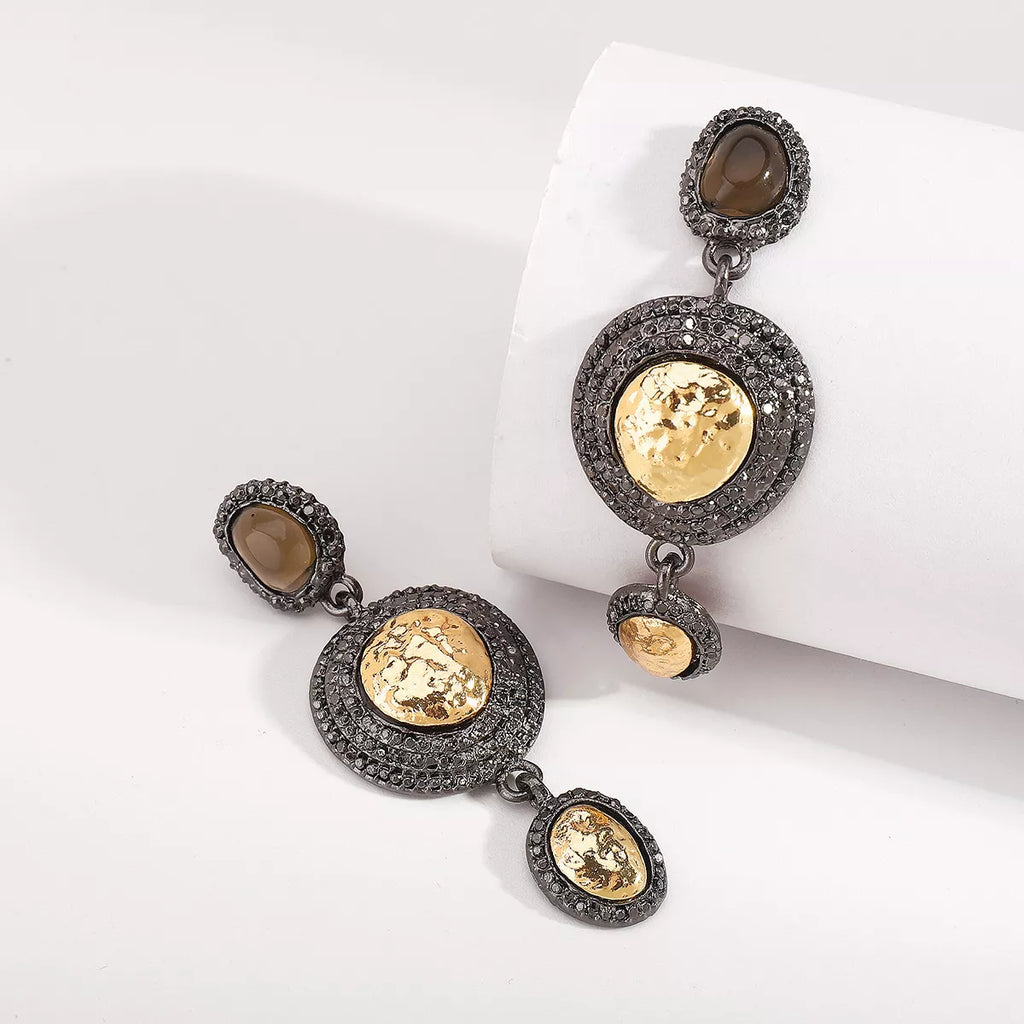 Vintage-inspired dangle earrings with gold accents, featuring intricate design and elegant craftsmanship.