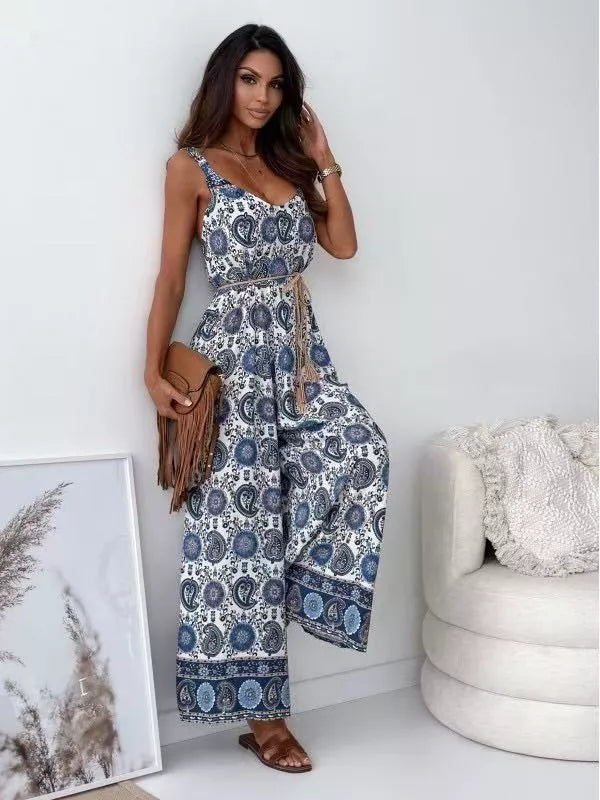Printed spaghetti strap wide-leg jumpsuit by Plush Fashion Hub with floral pattern and flowy silhouette, shown on a hanger.