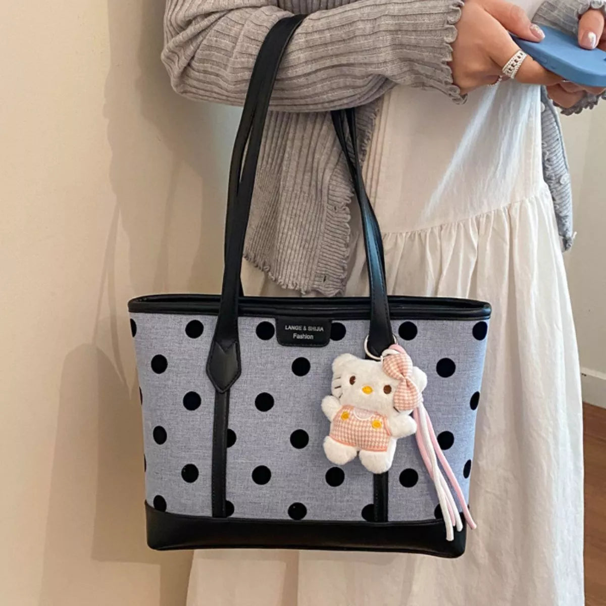 Polka dot shoulder handbag for women by Trendsi, stylish accessory with a compact design and adjustable strap.