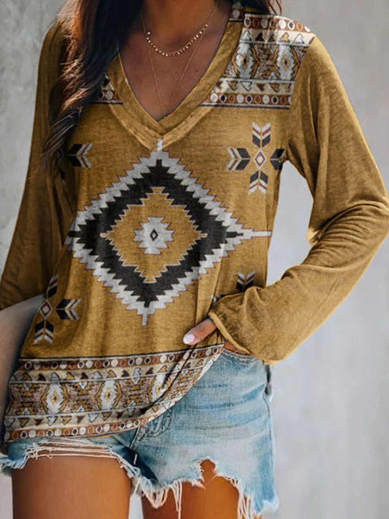 Plus size V-neck T-shirt by Trendsi featuring a geometric print, long sleeves, and a comfortable casual fit.