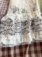 Boho patchwork lace-trimmed A-line tiered dress from Trendsi, featuring a flowy, bohemian-inspired design with layered fabric.