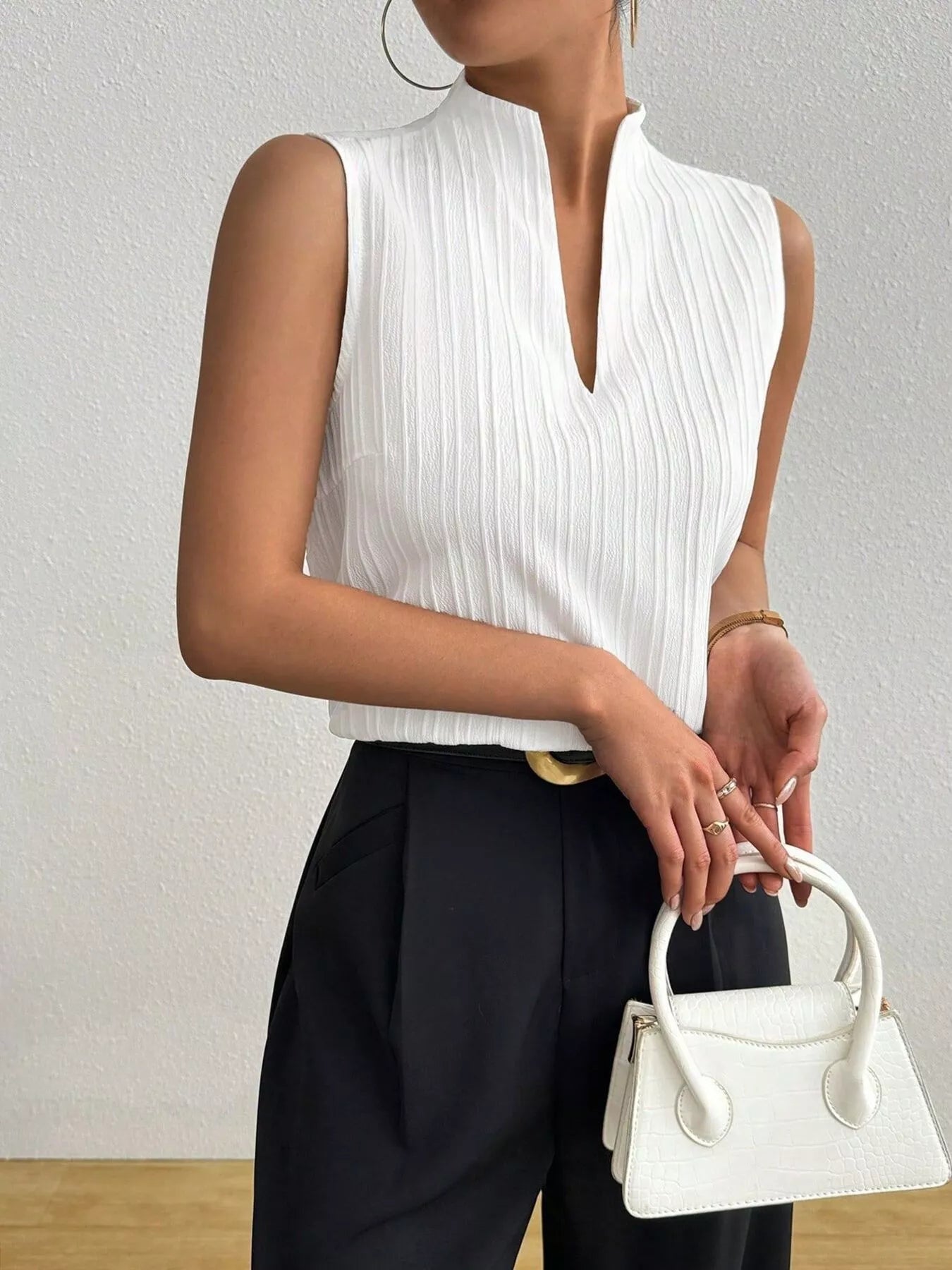 Women's textured notched neck sleeveless tank top, versatile basic shell from Trendsi, showing the fitted style and textured fabric.