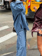 Women's striped button-up shirt and wide-leg pants two-piece set by Trendsi, featuring a stylish coordinated outfit.