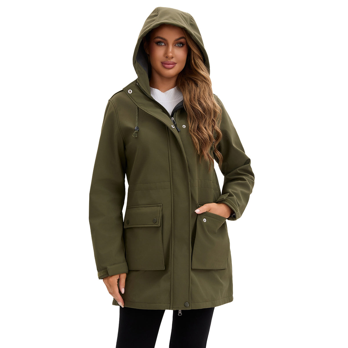 A woman wearing a solid olive-green hooded rain jacket with flap pockets, snap buttons, and a zipper.