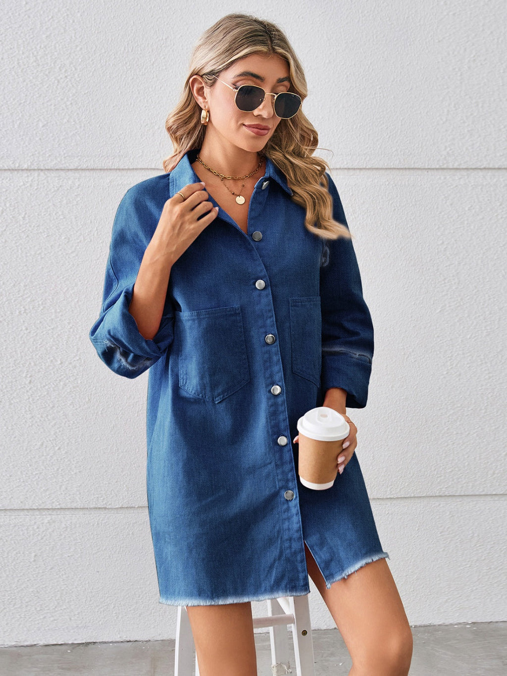 VYSN raw hem button-up denim dress displayed on a hanger, showcasing casual, stylish denim fashion for women.