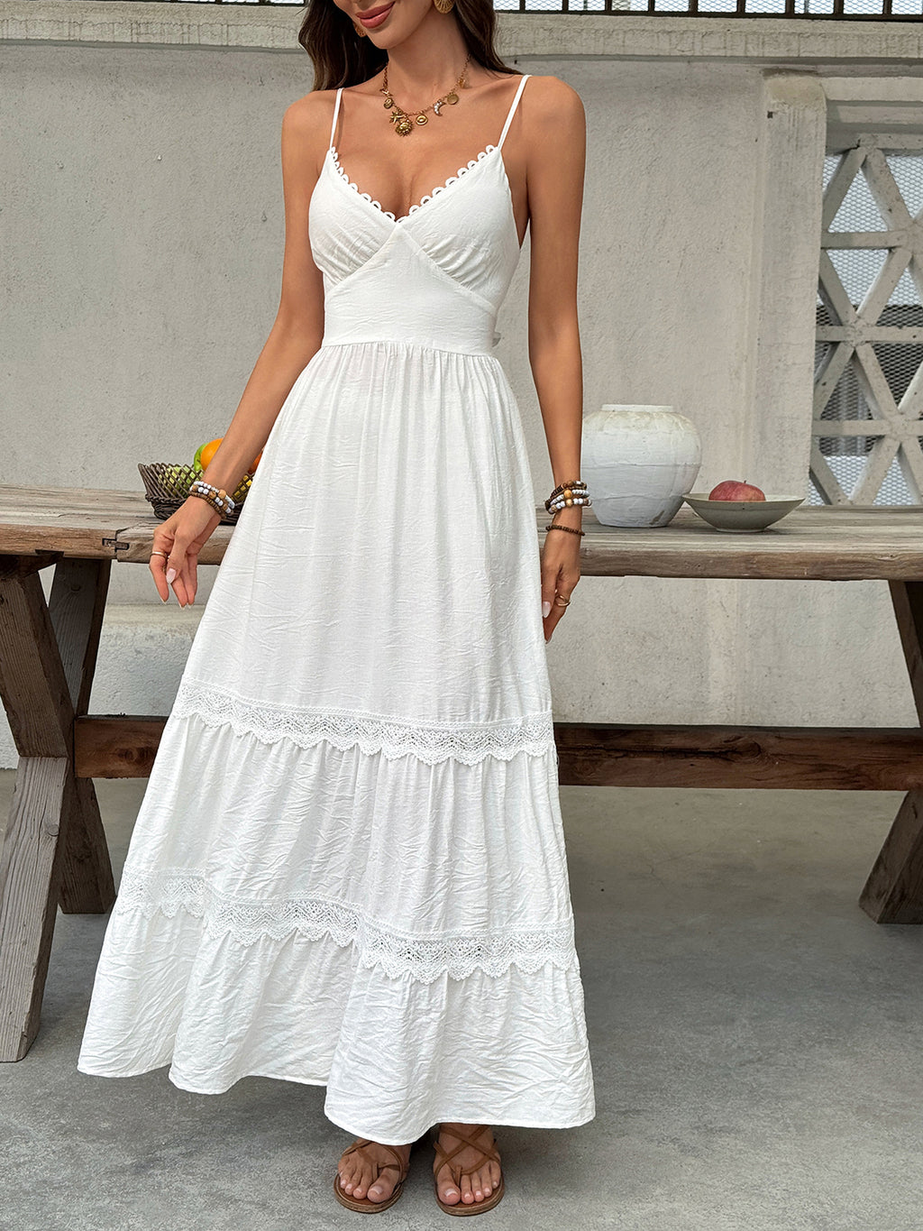 Women's V-neck tiered maxi dress with lace detail by Plush Fashion Hub, flowing fabric and elegant design.