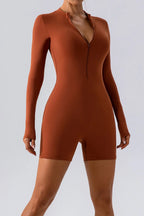 Trendsi half zip long sleeve active romper in black, featuring a fitted design and lightweight fabric for active wear.