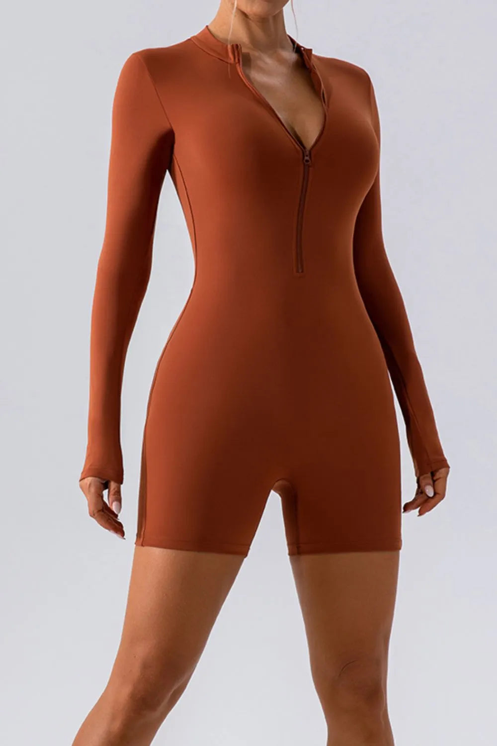 Trendsi half zip long sleeve active romper in black, featuring a fitted design and lightweight fabric for active wear.