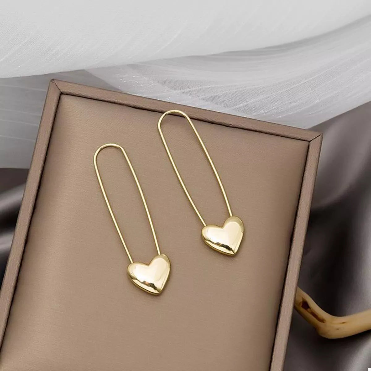 18K gold-plated heart charm safety pin earrings featuring a stylish design, perfect for adding a touch of elegance to your look.
