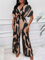 Abstract print wide-leg jumpsuit by Trendsi featuring a stylish, flowing design and vibrant pattern, perfect for casual or dressy occasions.