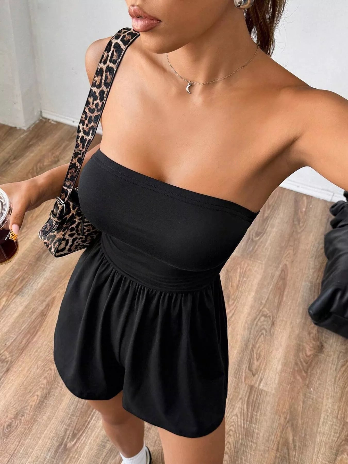 Chic strapless romper with ruched waist detailing, trendy fashion piece from Trendsi, shown in a stylish, fitted design.