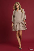 Umgee V-Neck Tiered Mini Dress in casualwear style, featuring a flowing silhouette and tiered design, displayed on a hanger.